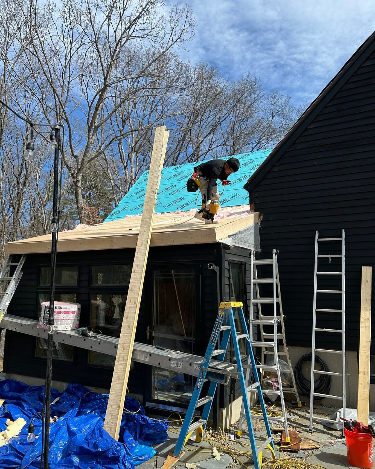 Crew installing metal roof